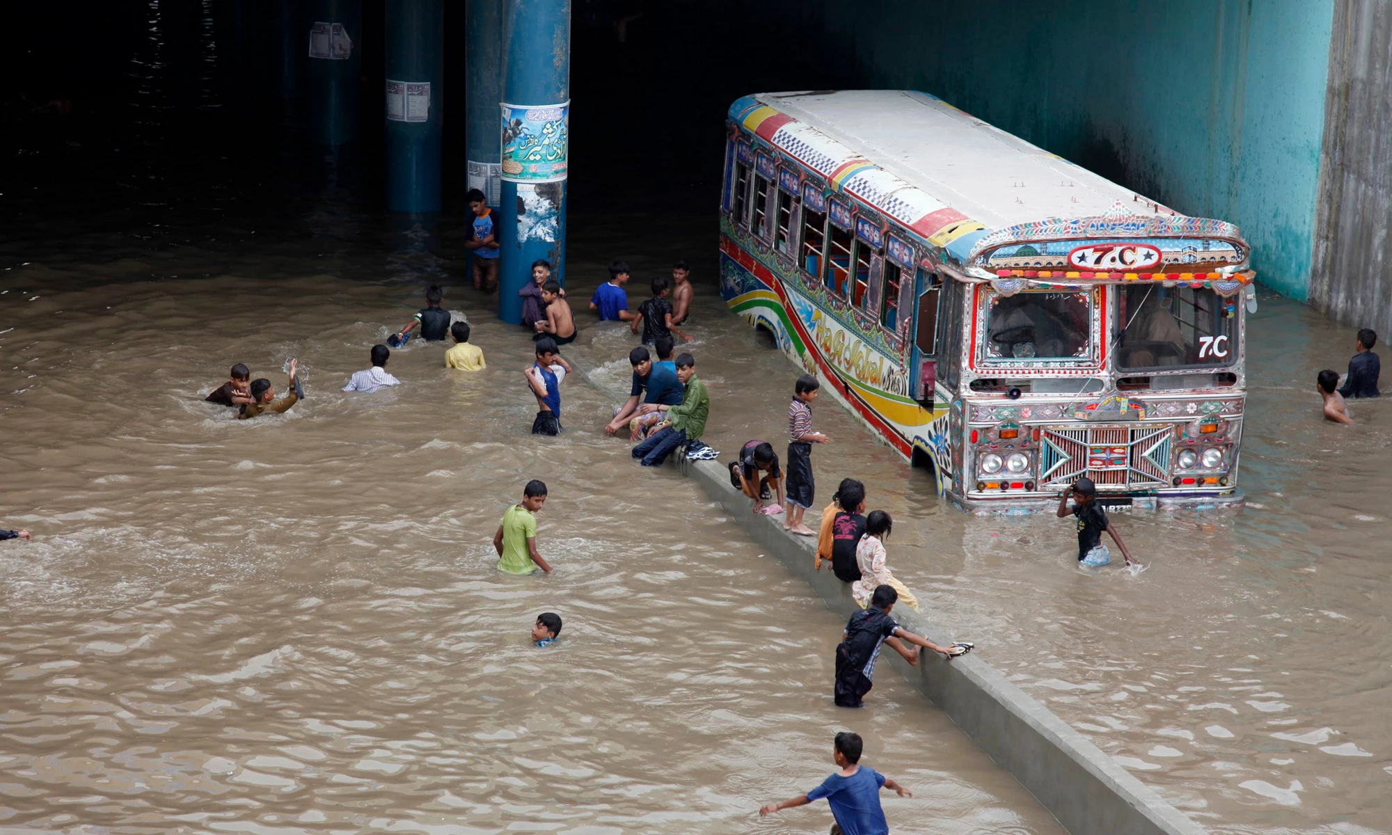 Flooded bus and passengers in Karachi floods