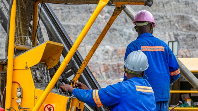 Workers operating heavy machinery at a diamond mine in Jwaneng, Botswana.