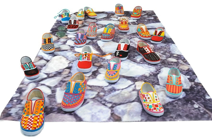 Helen Zughaib, The Places They Will Go, 2015-2016, dimensions variable, individual children’s shoes, painted in acrylic gouache on adhesive photo installation. © Helen Zughaib 