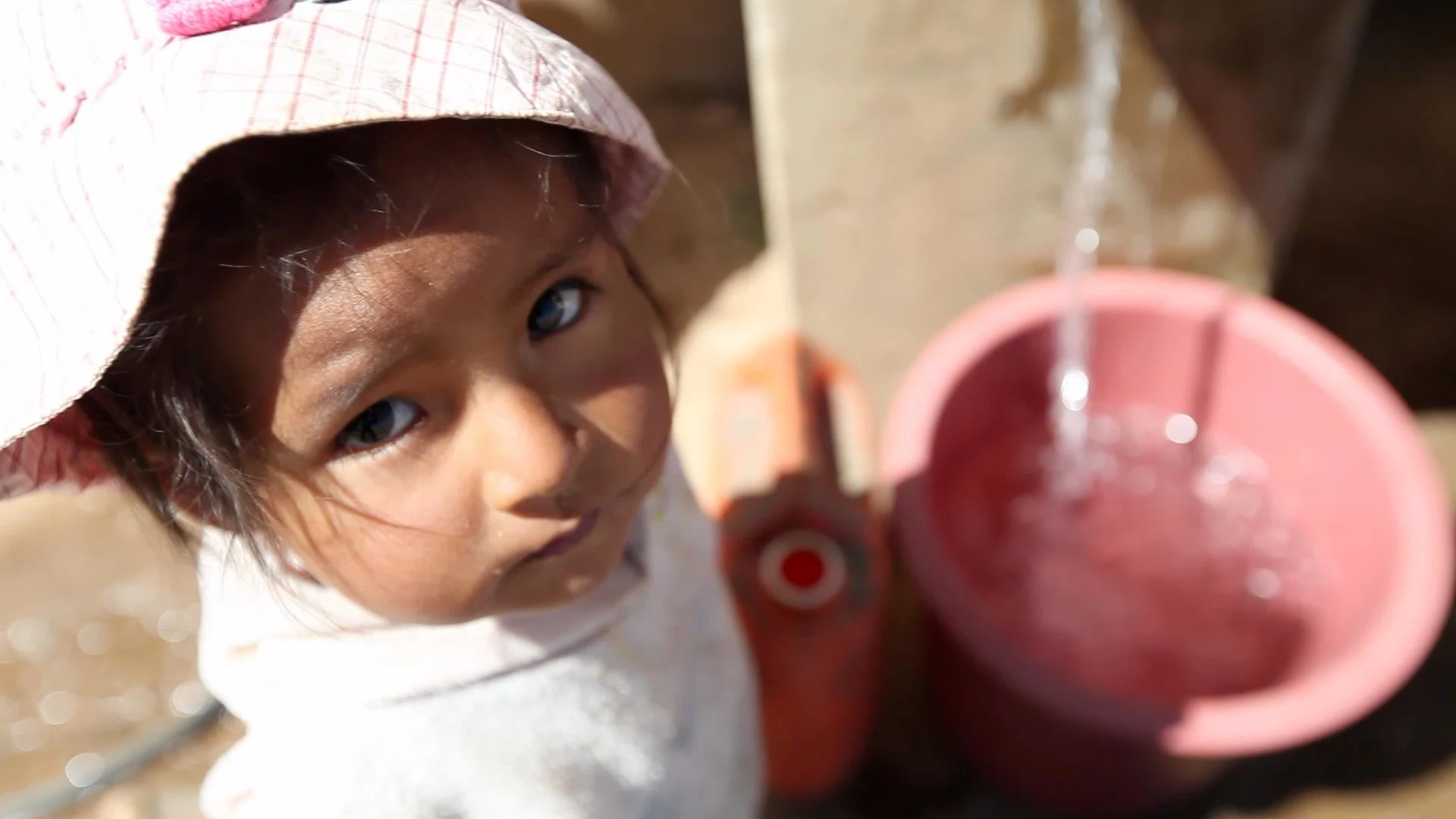 Child at public water station