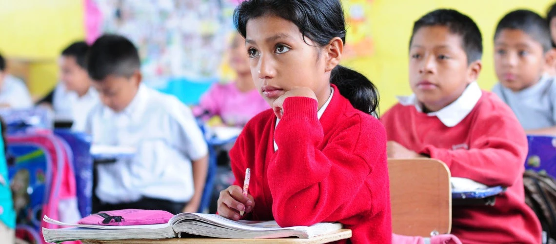 A girl pays attention in a classroom in El Renacimiento school, in Villa Nueva, Guatemala