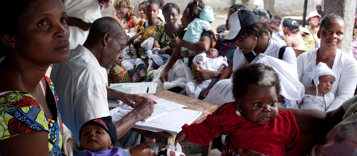 Community health worker helps document the wieght and growth of children at the Marechal Health Center