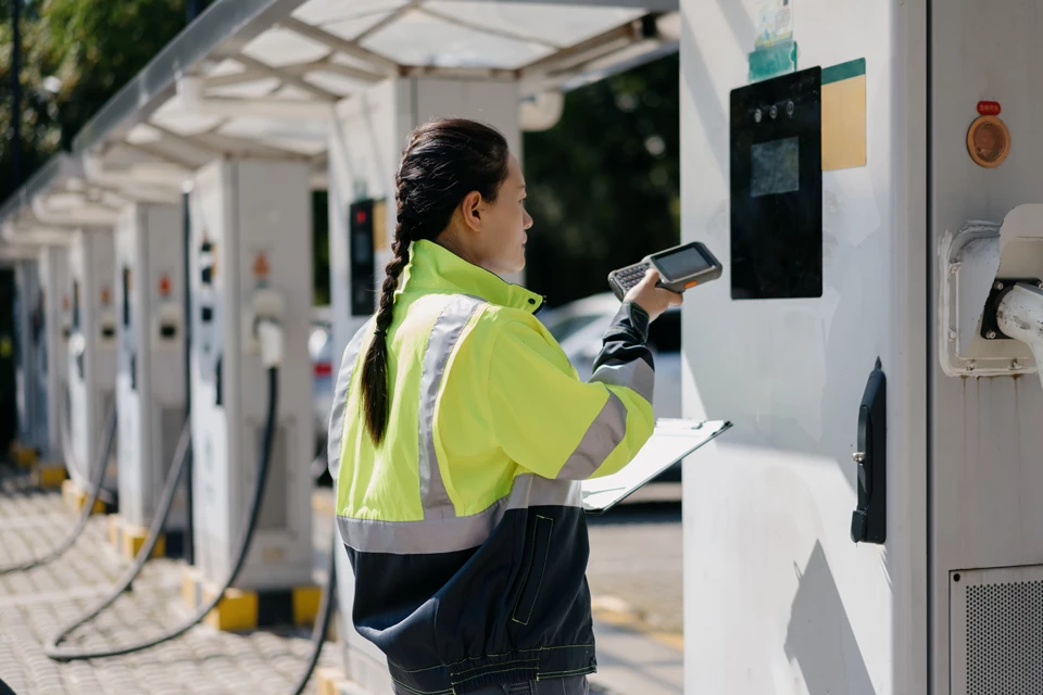 Female engineer is repairing the charging station 