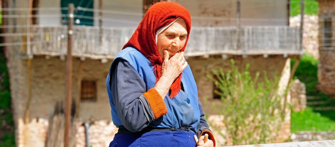 A woman sits by the side of the road outside of Skopje, FYR Macedonia.