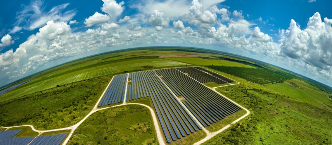 Aerial view of agricultural farm fields with solar photovoltaic panels for producing clean energy