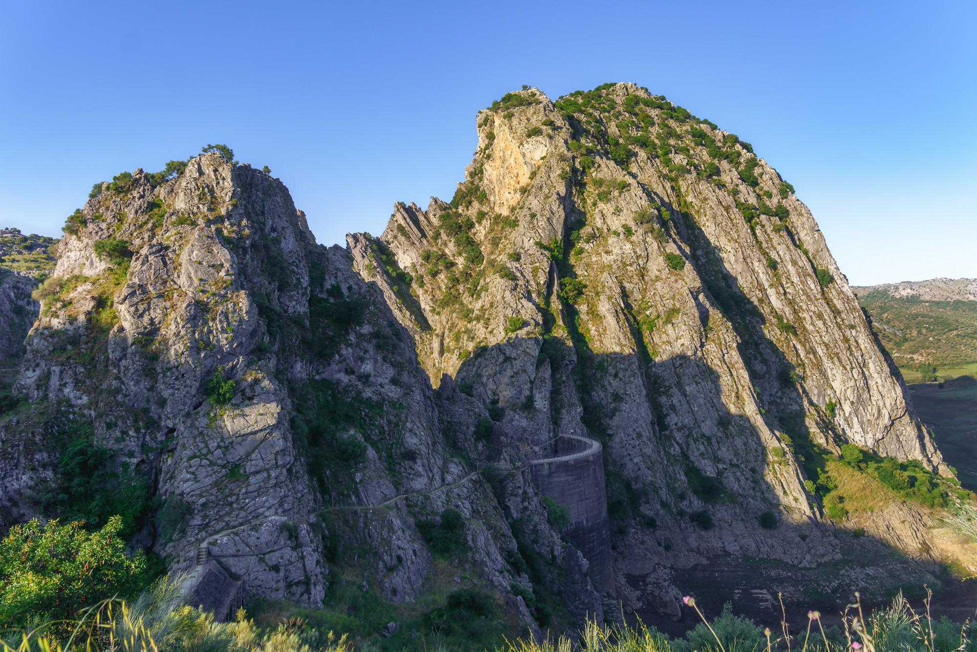 Breathtaking view of rocky cliffs and a dam nestled amidst the rugged landscape