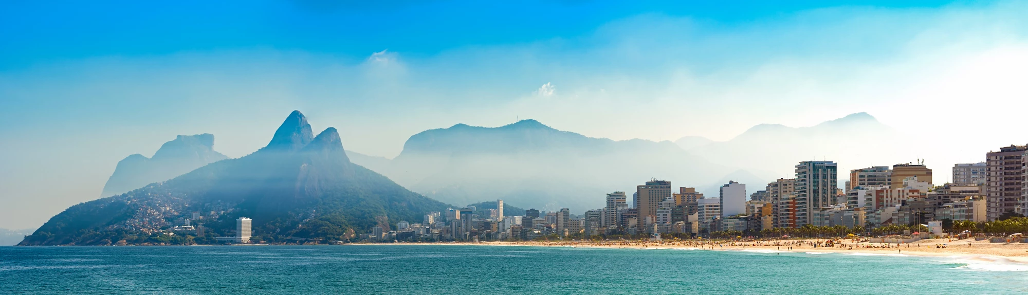 Panoramic landscape of the beaches of Arpoador, Ipanema and Leblon in Rio de Janeiro with sky and the hill Two brothers, Vidigal, and GÃ¡vea stone in the background