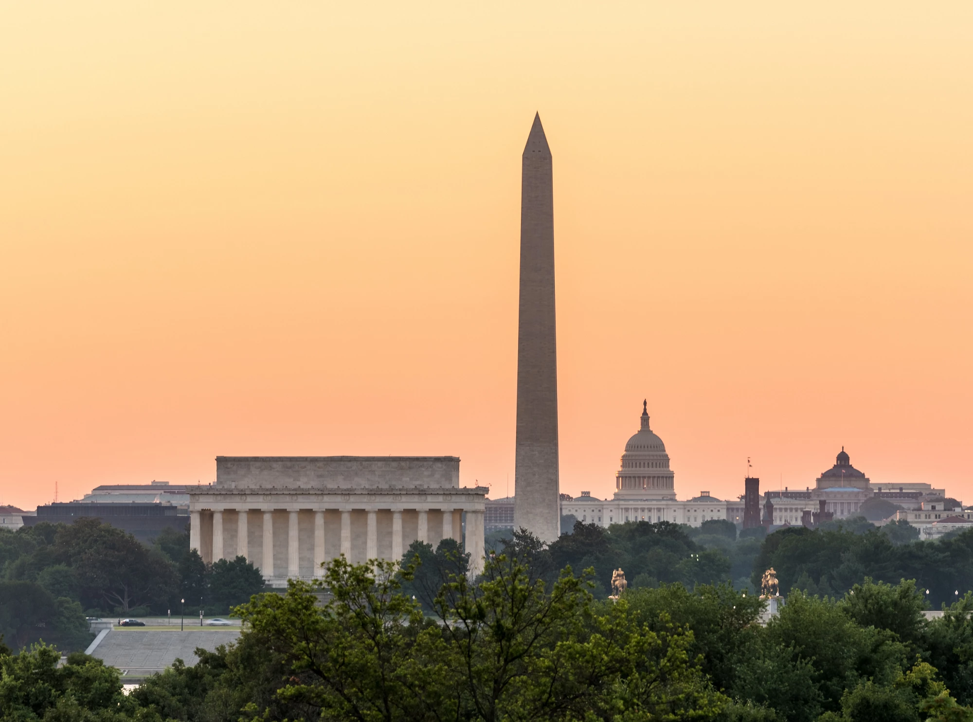 Dawn and sunrise over nations capital with all monuments aligned against orange sky