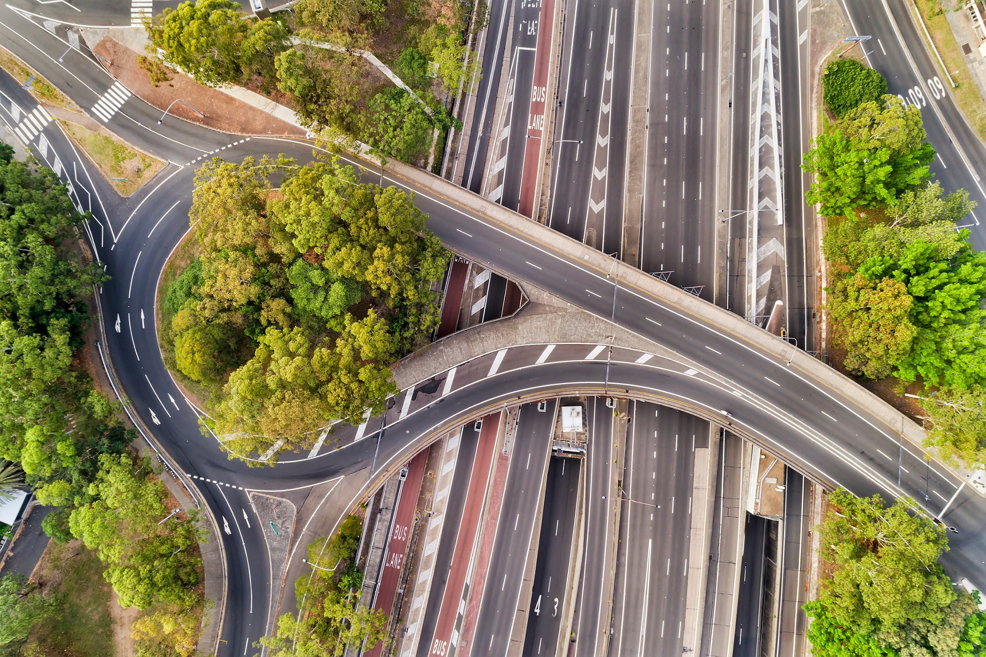 Warringah freeway at multi-level intersection of North Sydney when crossing street forms round about and a bridge at times with no traffic. Aerial view over empty lanes of the biggest sydney motorway.