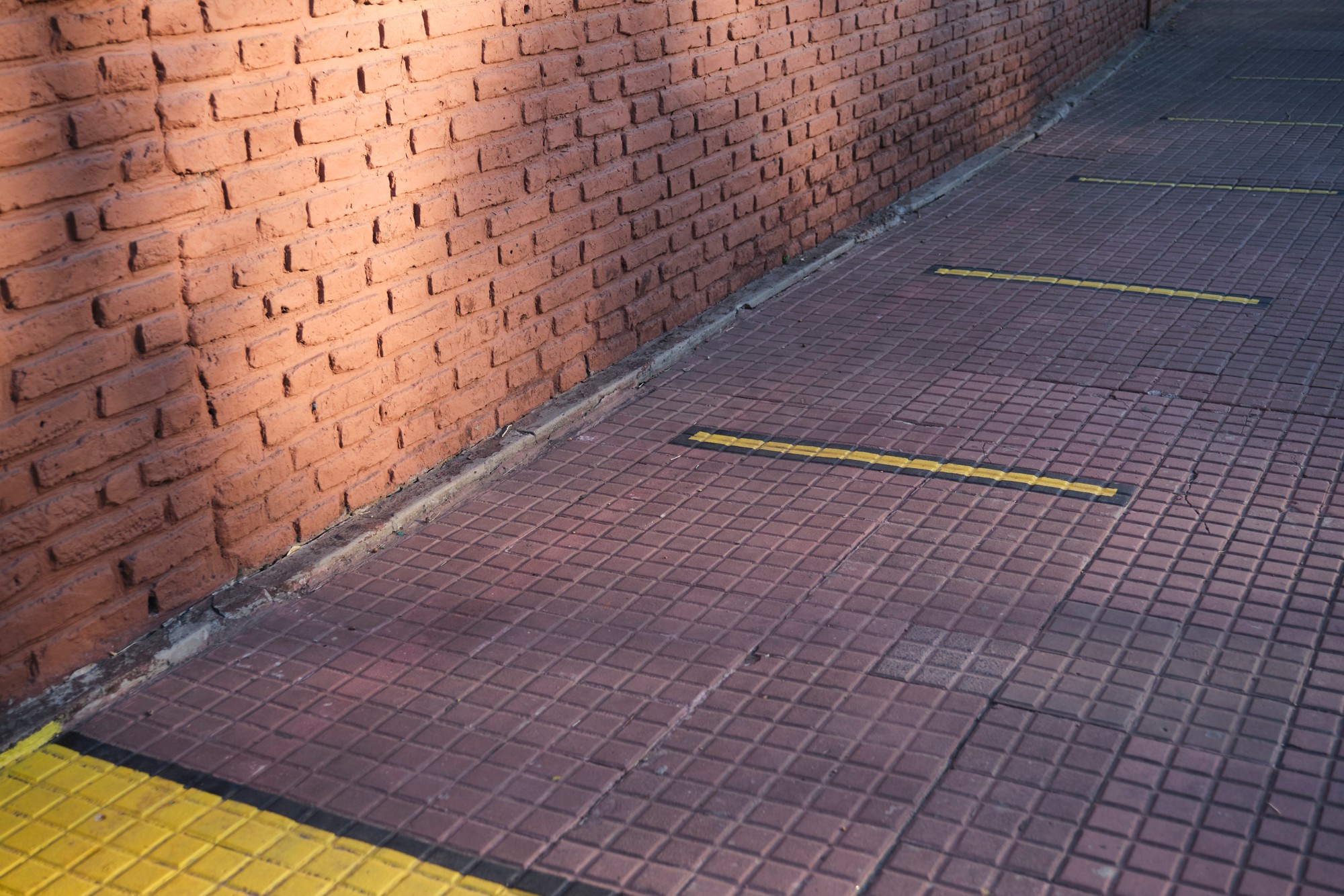 Outdoor floor marked with yellow lines to maintain social distance during the coronavirus pandemic, covid-19
