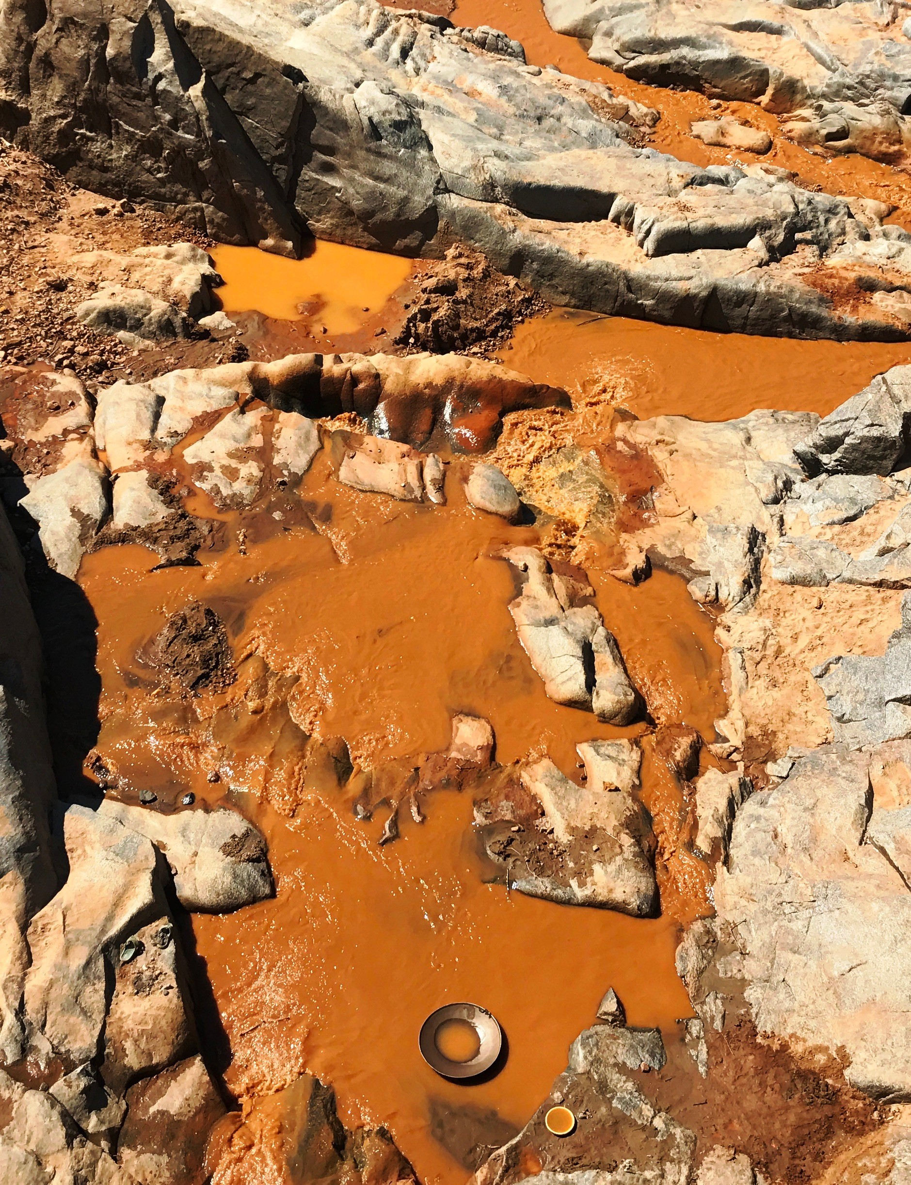 Artisanal gold mining near Antsirabe, Madagascar. Panners wash extracted soil as they pan for gold. Malagasy golden miners in river Tsiribihina. Ore mineral extraction