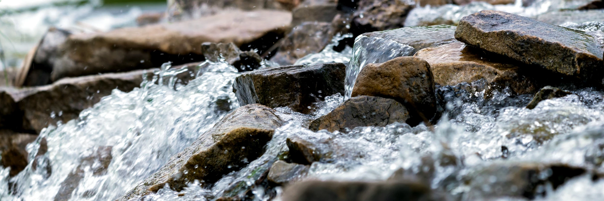 Close up of river stream on stones.