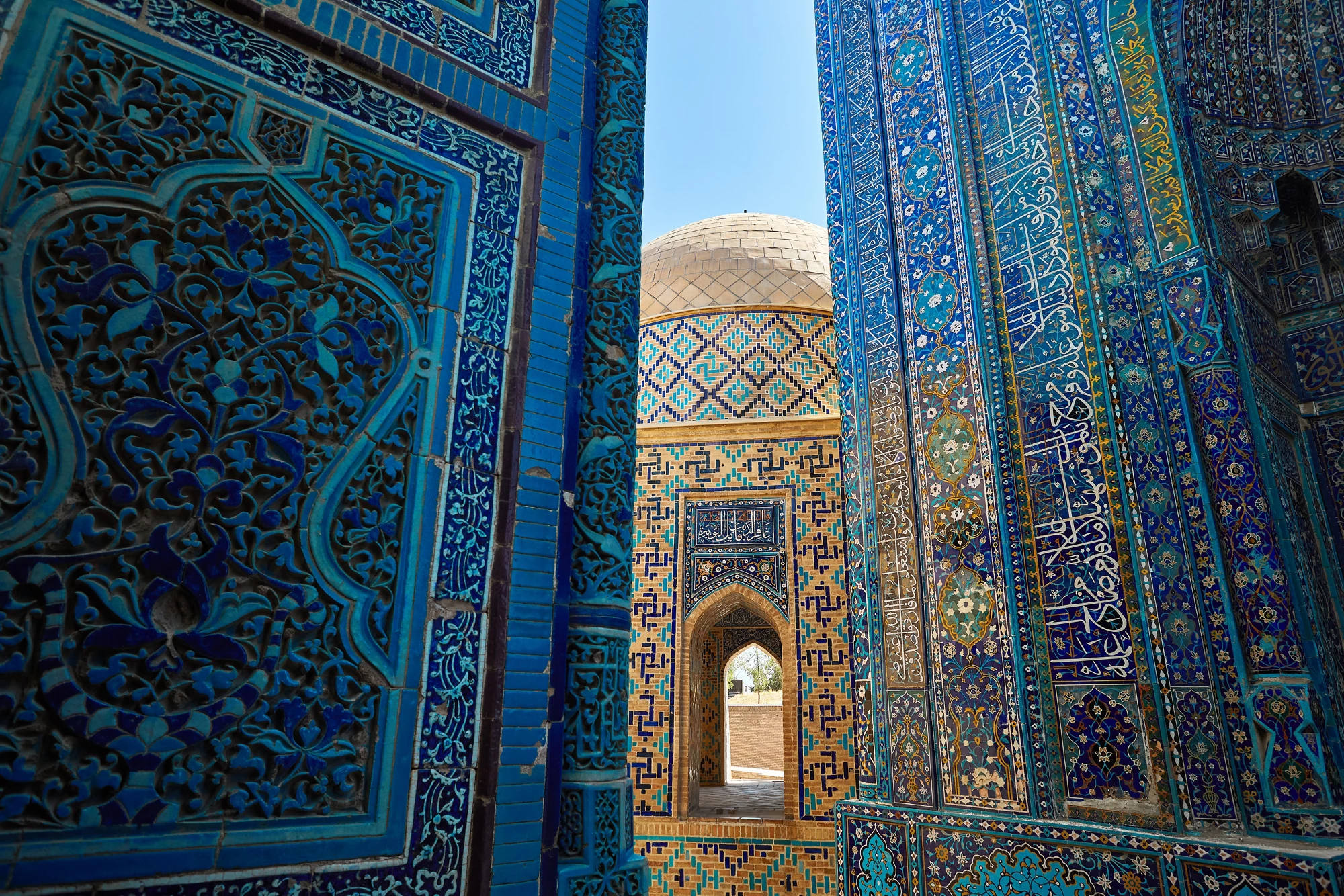 Beautiful Arch entrance of Historical cemetery of Shahi Zinda with finely decorated by blue and turquoise stone mosaic mausoleums in Samarkand, Uzbekistan.