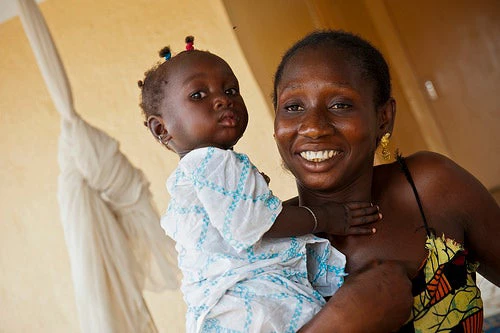 A mother in Africe holds up her child.