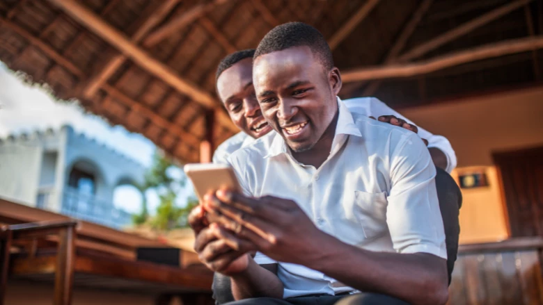 African teenager with mobile by zeljkosantrac from Getty Images Signature