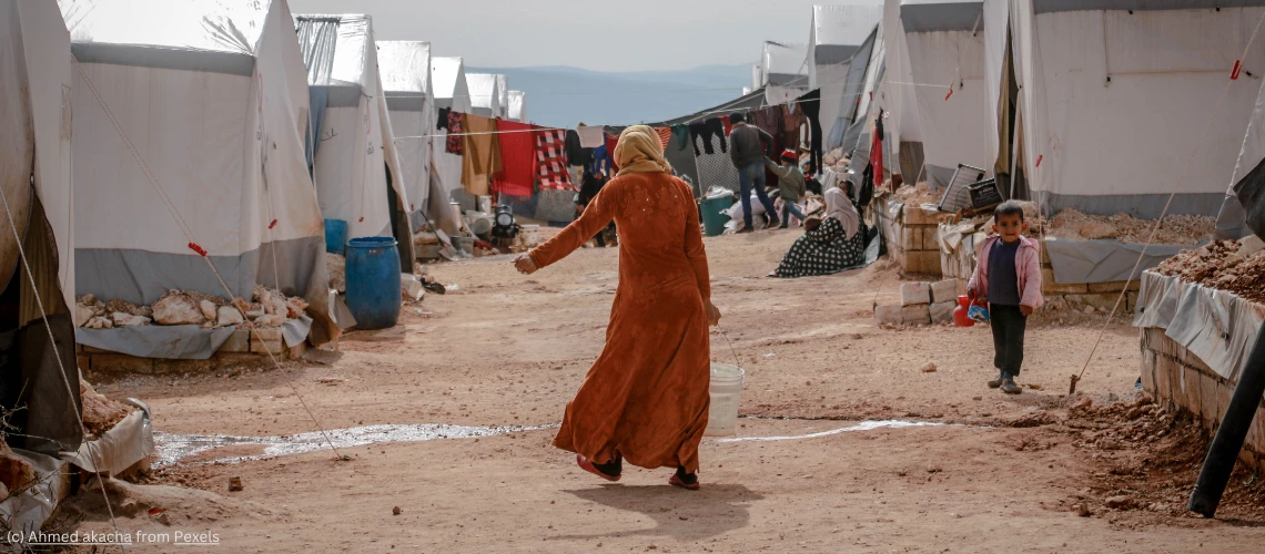 Anonymous woman walking in refugee camp