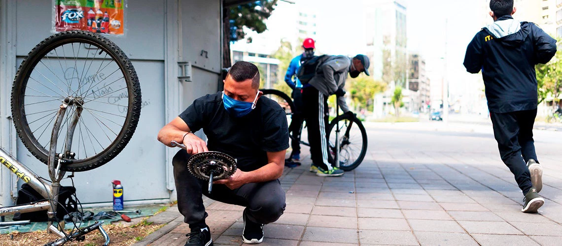 Emprendedor en su taller arreglando bicicleta en las calles de Quito, Ecuador