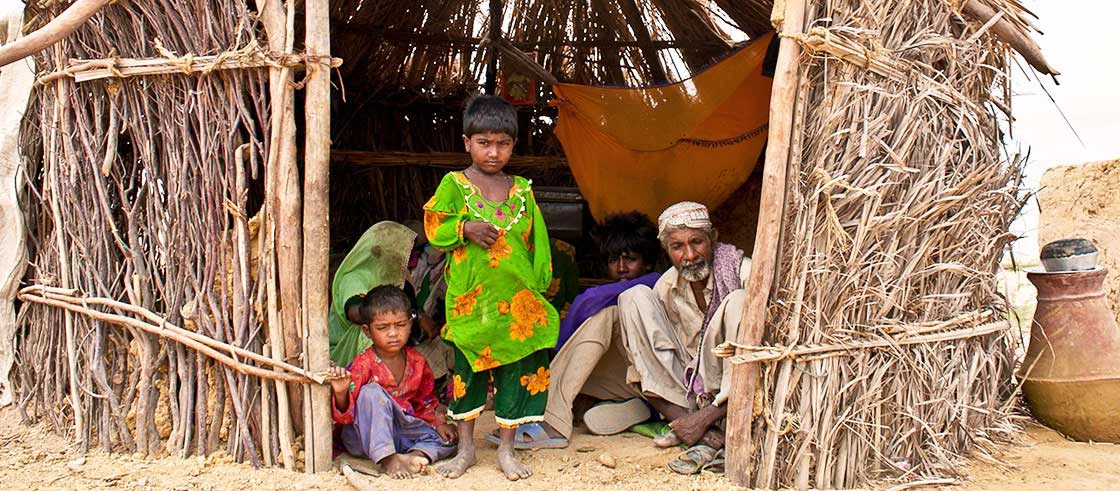 Family staying in small hut in rural Sindh Pakistan.