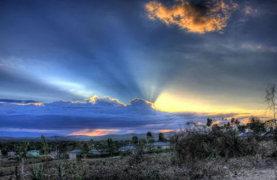  Sun rising behind clouds in Haiti. Source - Yinan Chen