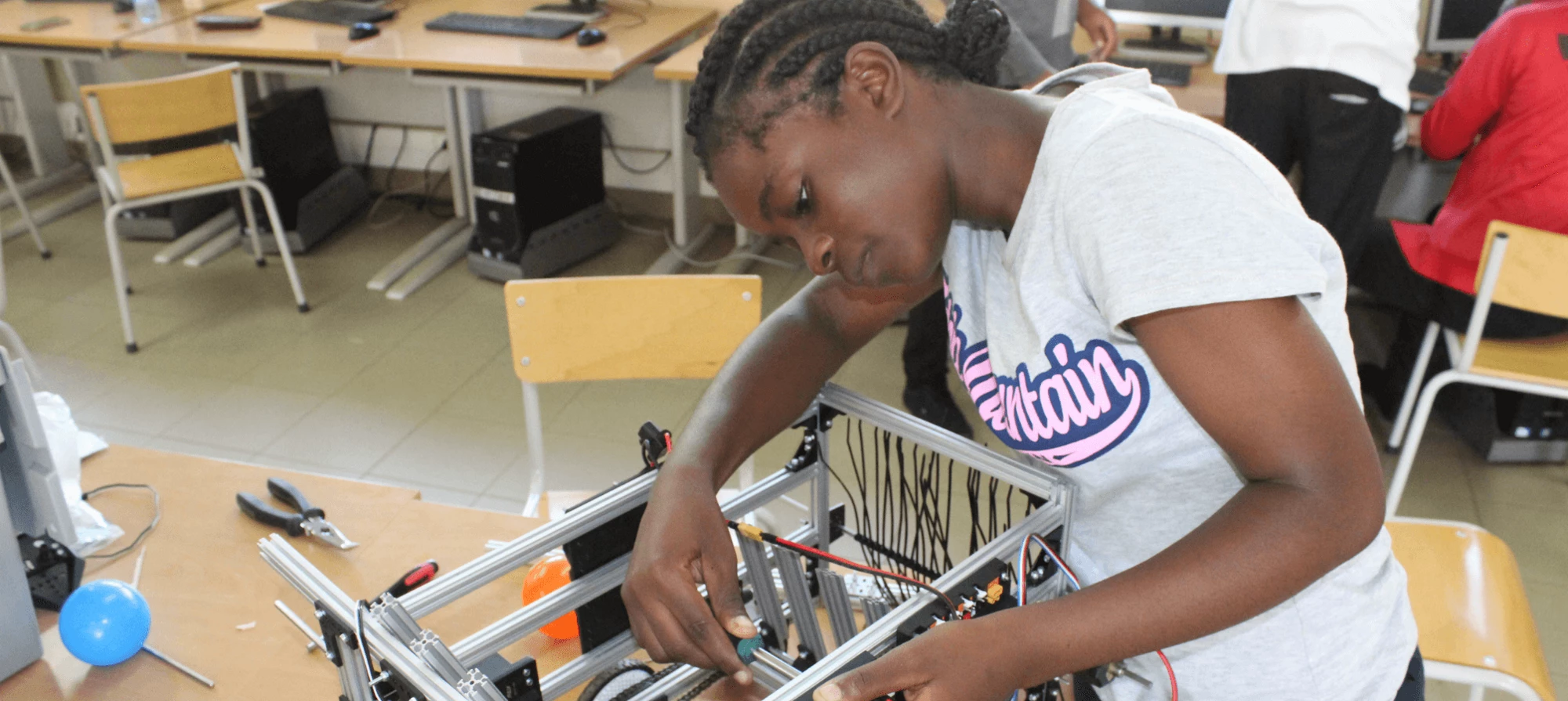 a girl in a class of robotics in Maputo