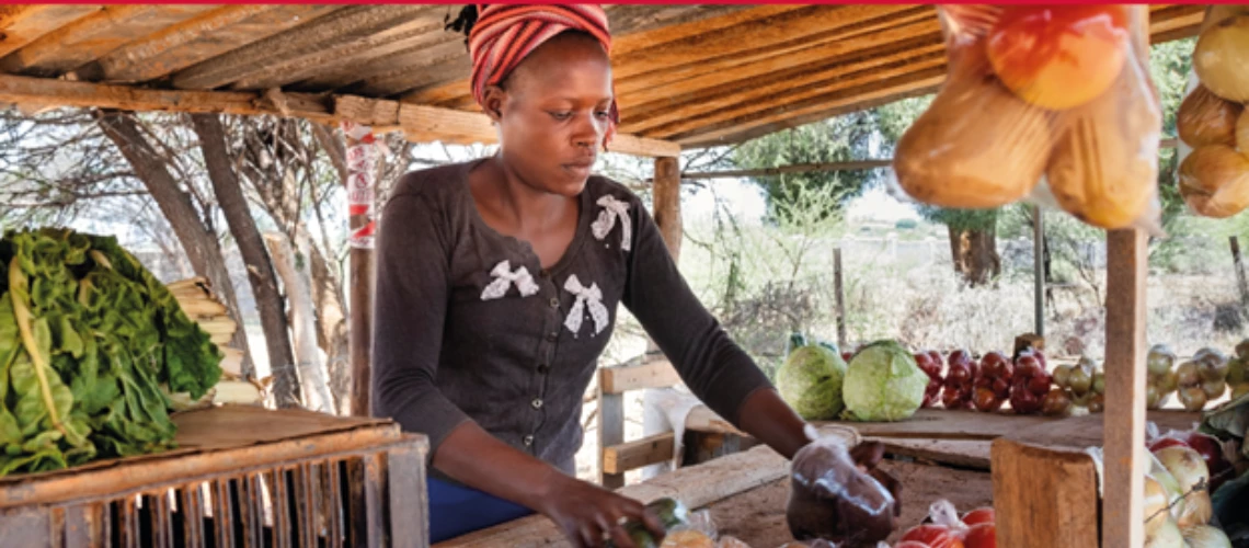 A woman at the market selling fruits