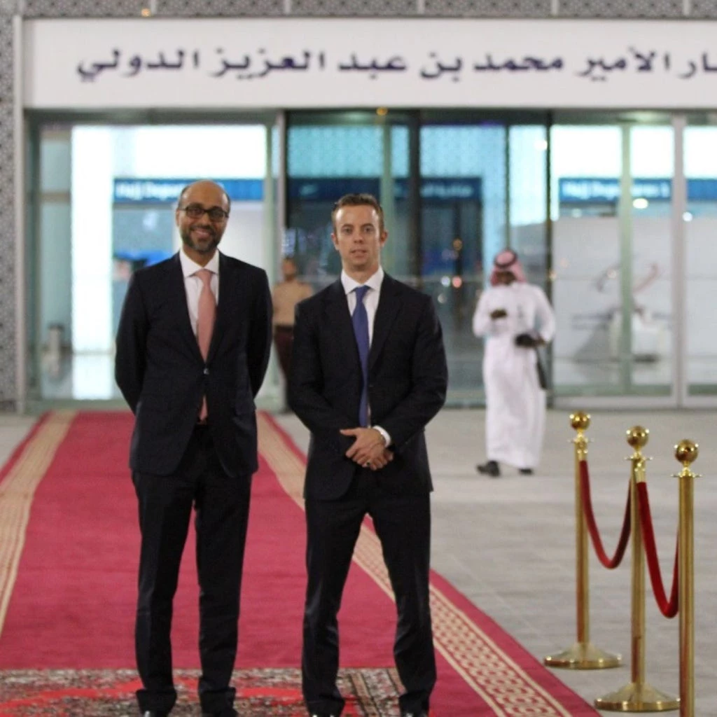 Muneer Ferozie and Alexandre Leigh of IFC?s PPP team who successfully led the Madinah airport PPP restructuring, stand at the entrance of the airport during the opening of its new terminal.