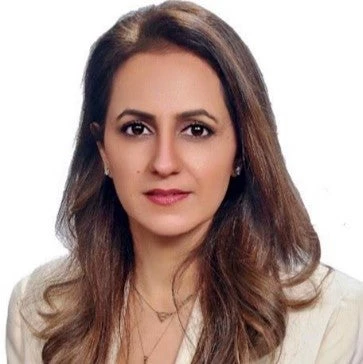 Izza Farrakh, woman with long brown hair, in white blouse