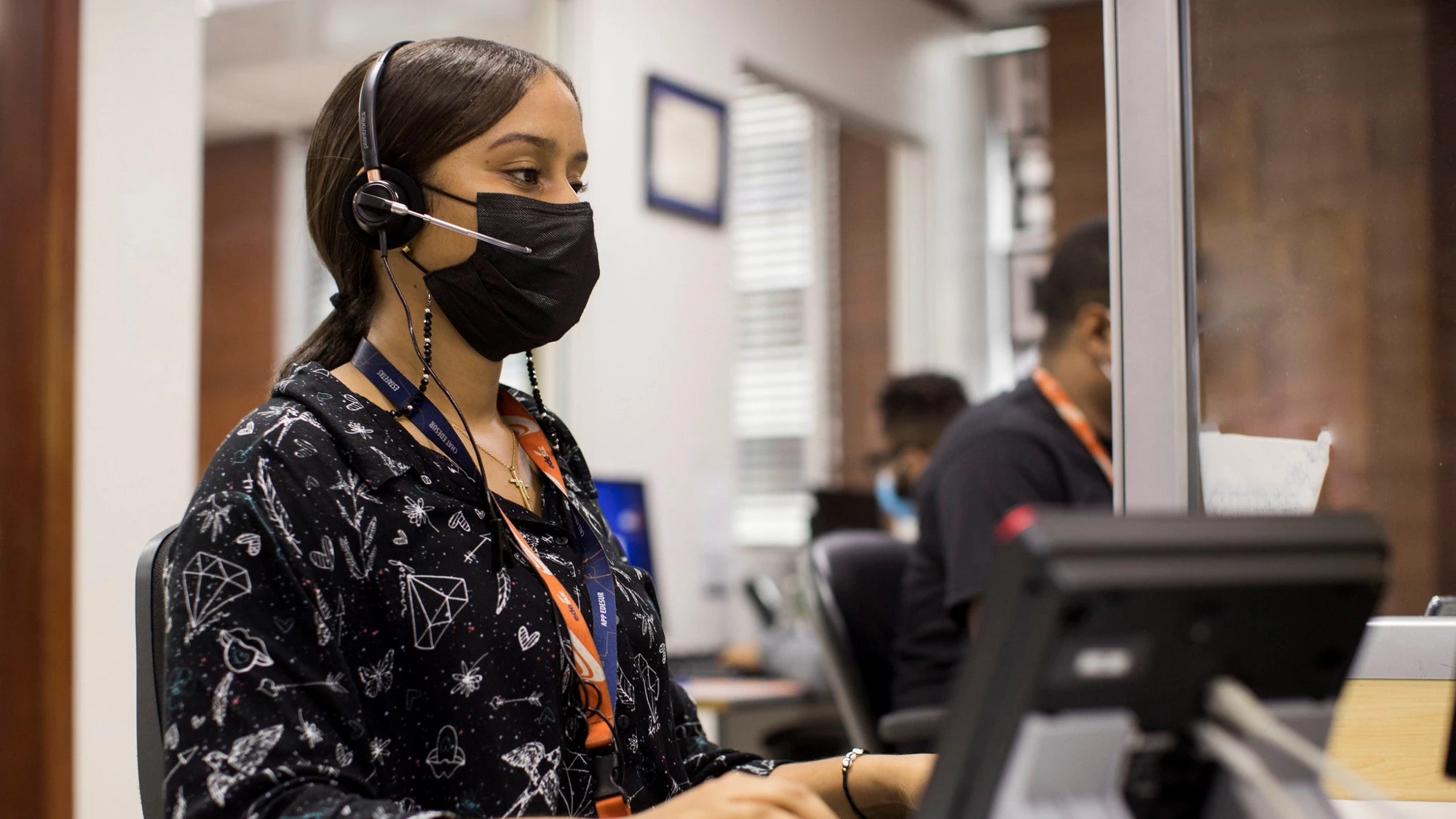 Lady working on computer with mask