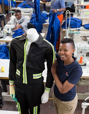 Thabi Mkhwanazi show the various style workers clothes that they produce at the Khanyile Solutions factory in Johannesburg, South Africa, Friday, 05, Oct 2018.Photo/Karel Prinsloo/IFC