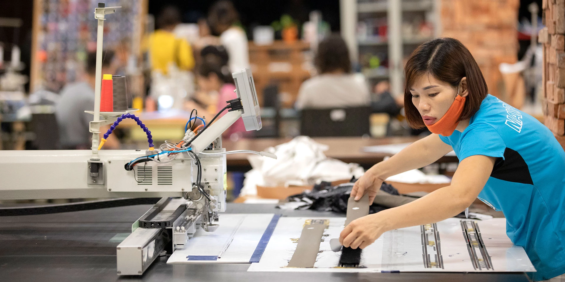 Maxport Limited employees work in the Hanoi facilities in Hanoi, Vietnam on July 27, 2019. Maxport Limited employs 6,500 workers and sells high-end sportswear primarily to Nike and Lululemon. Maxport Limited is also an Employer of Choice for Women, including EDGE (Economic Dividends for Gender Equality) assessment and certification, gender equal leadership pipeline development, and a strategy to support workers with childcare. Photo @ Dominic Chavez/International Finance Corporation
