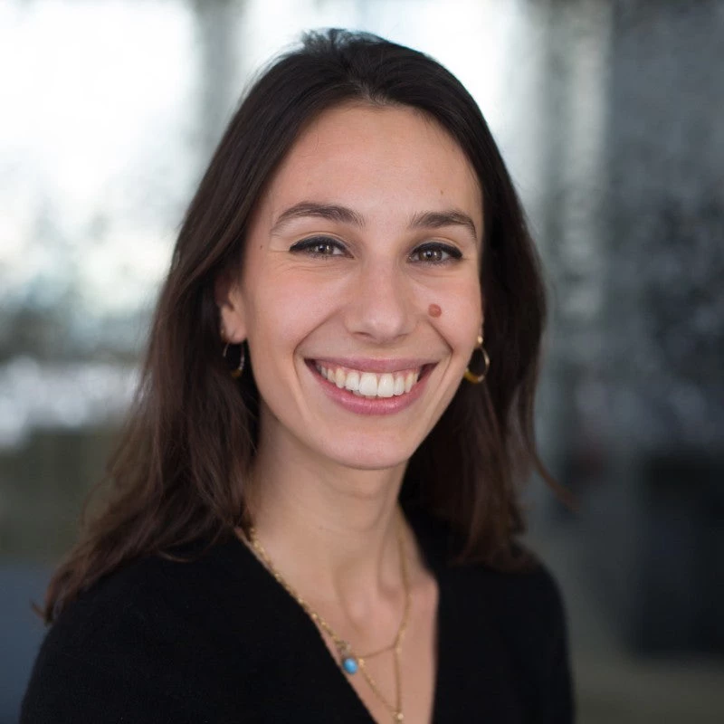 Dark haired woman smiling. 