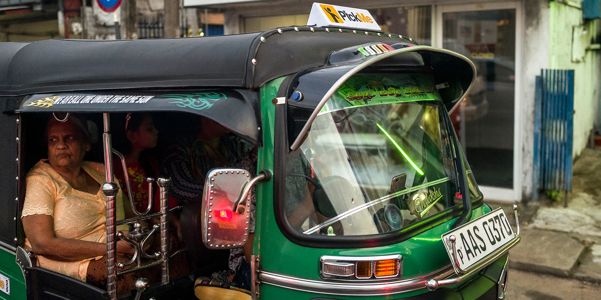 COLOMBO, SRI LANKA – DECEMBER 14: A customer is seen while being driven inside a Pick-Me "three wheeler" on the outskirts of the Sri Lankan capital on December 14, 2018 in Colombo, Sri Lanka. Pick-Me's future plans includes expanding the business into the food delivery services, and gradually incorporating electrical "three wheelers" to help minimize pollution in the country in an effort to reshape the transportation industry in Sri Lanka. Photo by Omar Havana / IFC