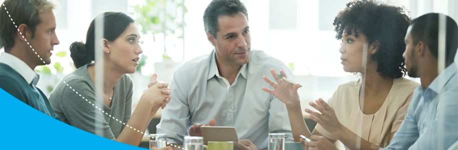 A group of people sitting at a table and discussing