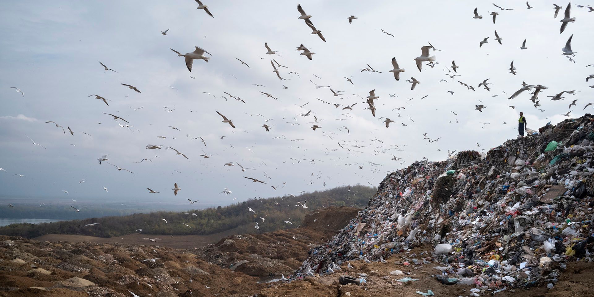 On October 31, 2019, a waste picker looks toward the Danube River while working at the Vinča Landfill in Belgrade, Serbia. The landfill’s trash is rolling toward the Danube, and is leeching toxic water into the water supply. Photo © Dominic Chavez/International Finance Corporation