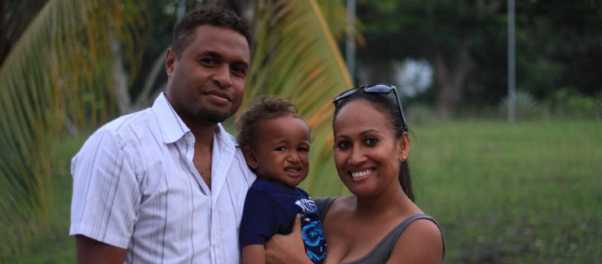 Solomon Islander man and woman hold their baby