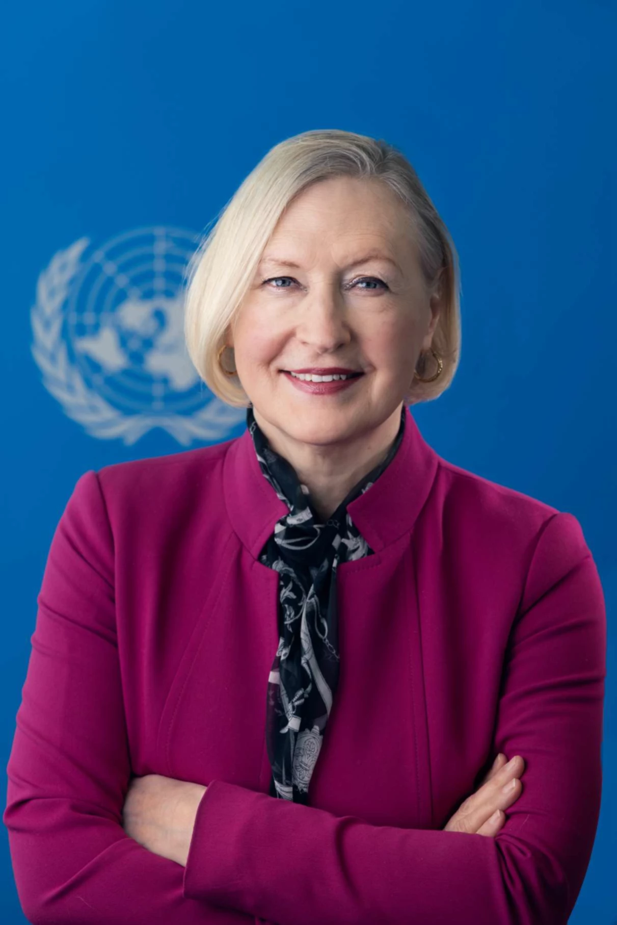 Blonde woman wearing magenta blazer.