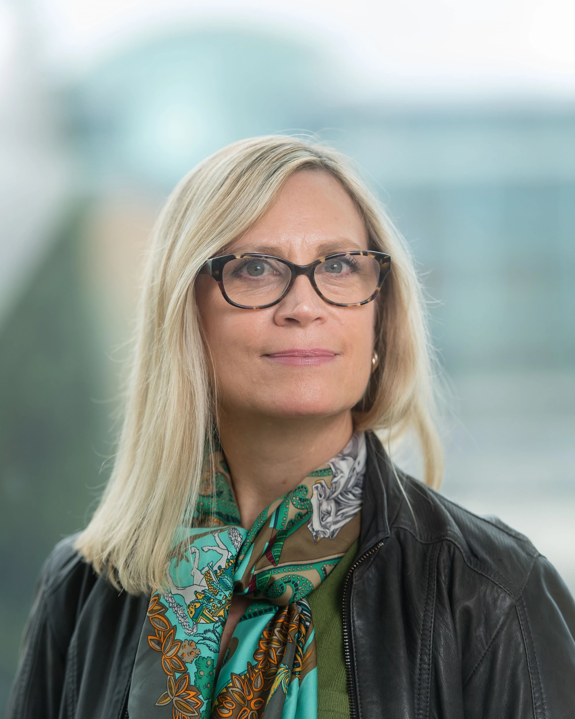 Victoria Lemieux, a woman with blonde hair and a glasses, looks into the camera