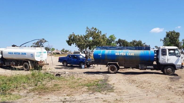 Two tanker trucks bring water to the Bidibidi refugee settlement in Uganda