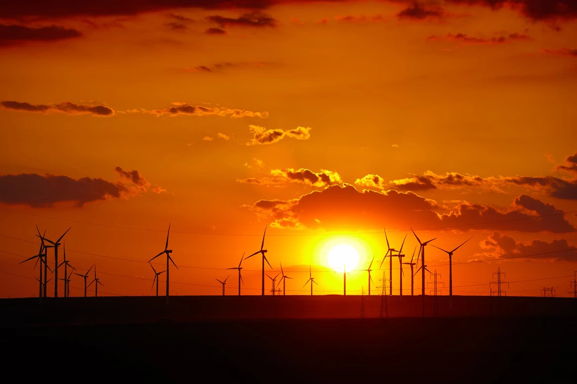 Wind turbines farm at sunset in Dobrogea region of Romania