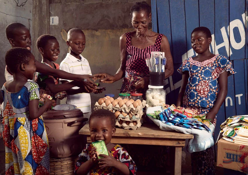 Woman runs a makeshift grocery in the streets of Bè-Ablogamé, a rundown neighborhood in the port district of Lomé, Togo.