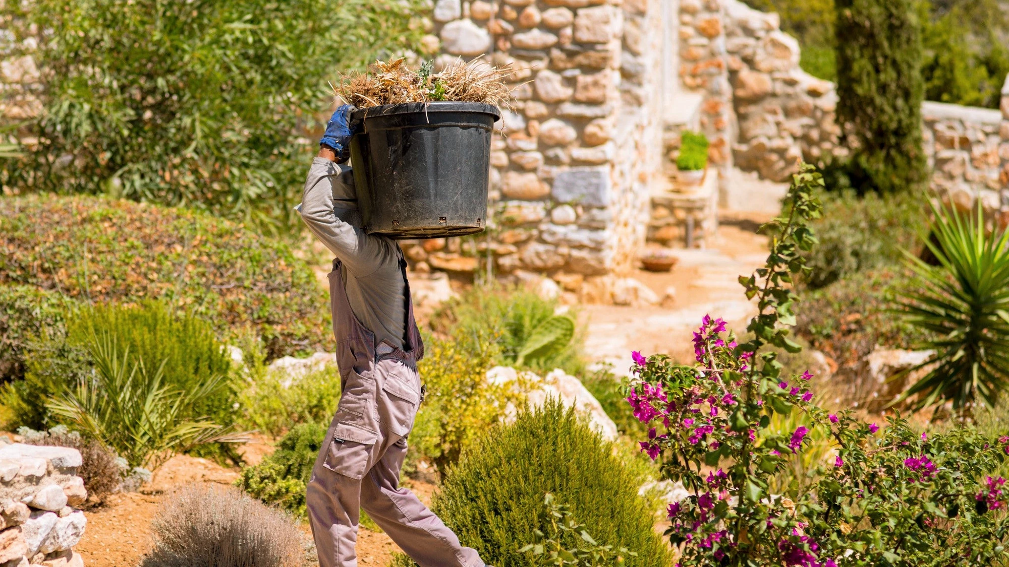 A worker in a garden in Greece