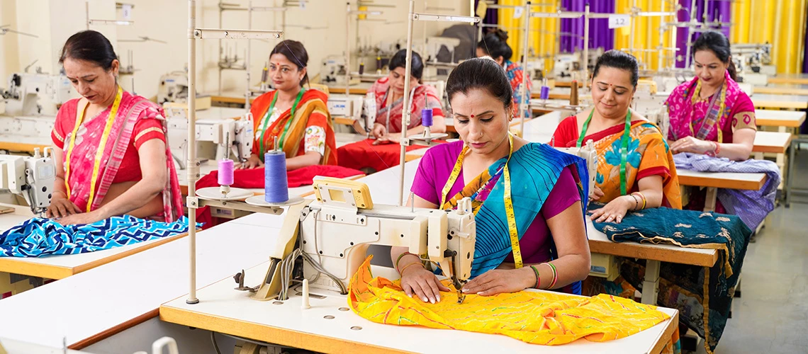 A group of women working at textile factory. | © PRASANNAPIX / Adobe Stock