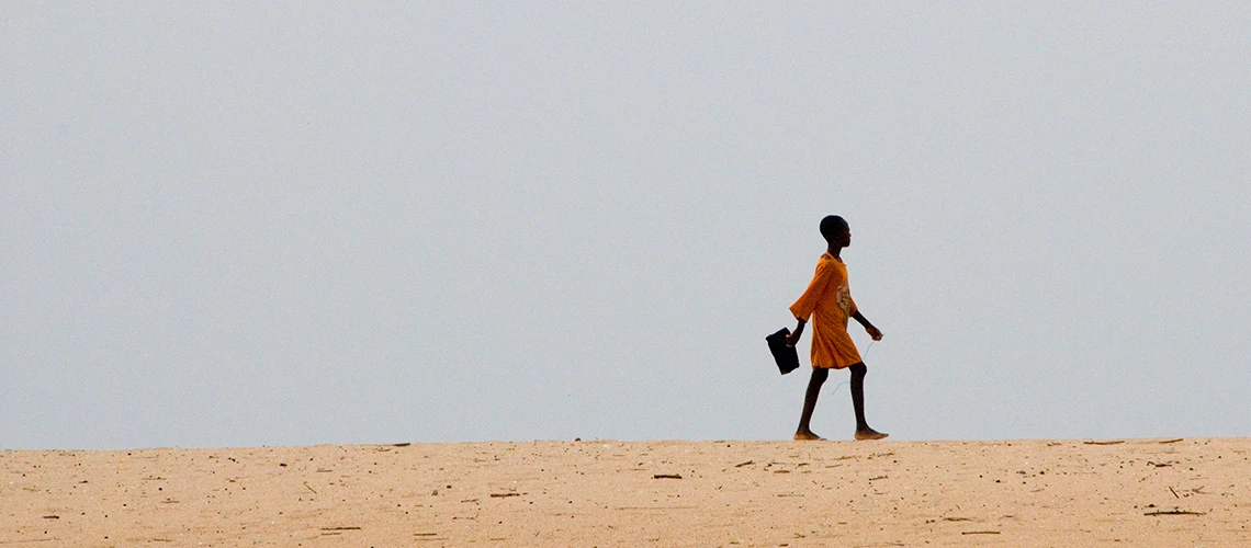 Young girl walkiang to school. | © Arne Hoel / The World Bank