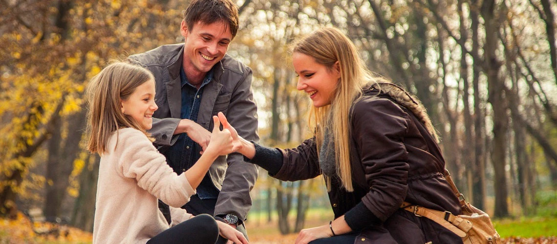 A cheerful family playing in the park in Zagreb