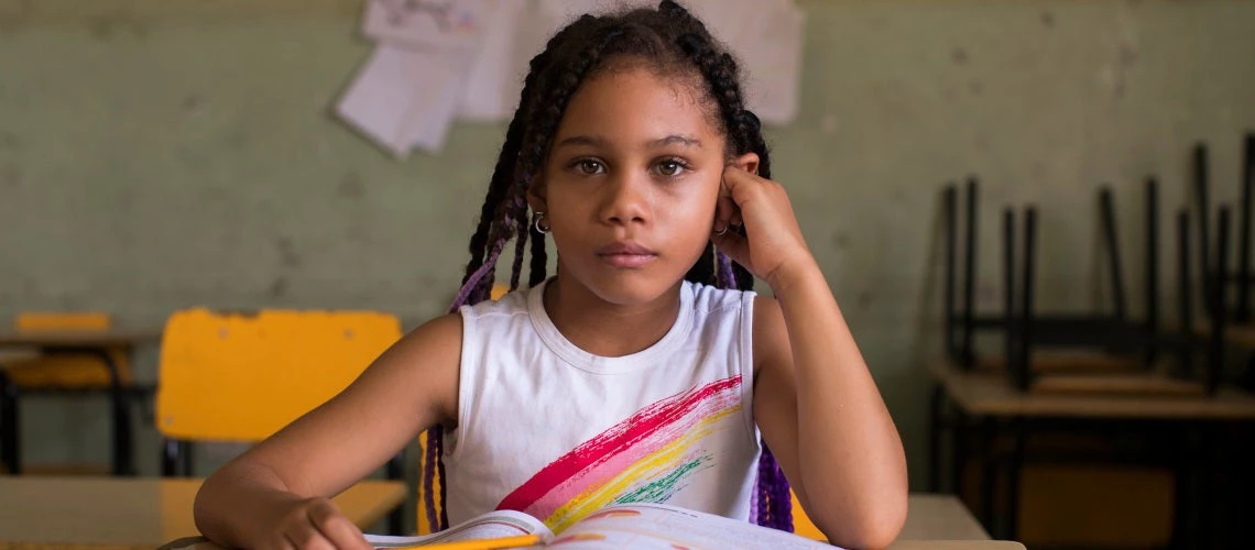 A girl plays with an abacus at the New Salome Ureña School in the Capotillo neighborhood in the city of Santo Domingo on June 25,