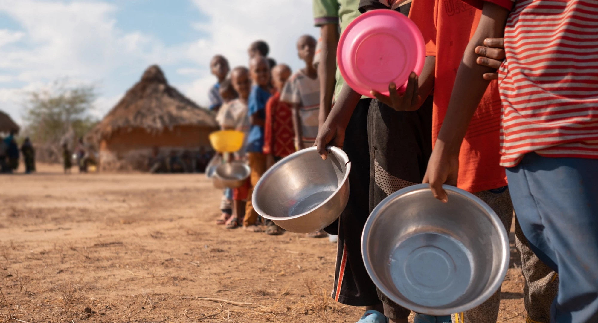 People queuing for water. Photo credit: © Suheyp / Adobe Stock