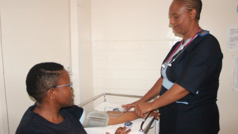 Nurse taking patient's blood pressure in Lesotho