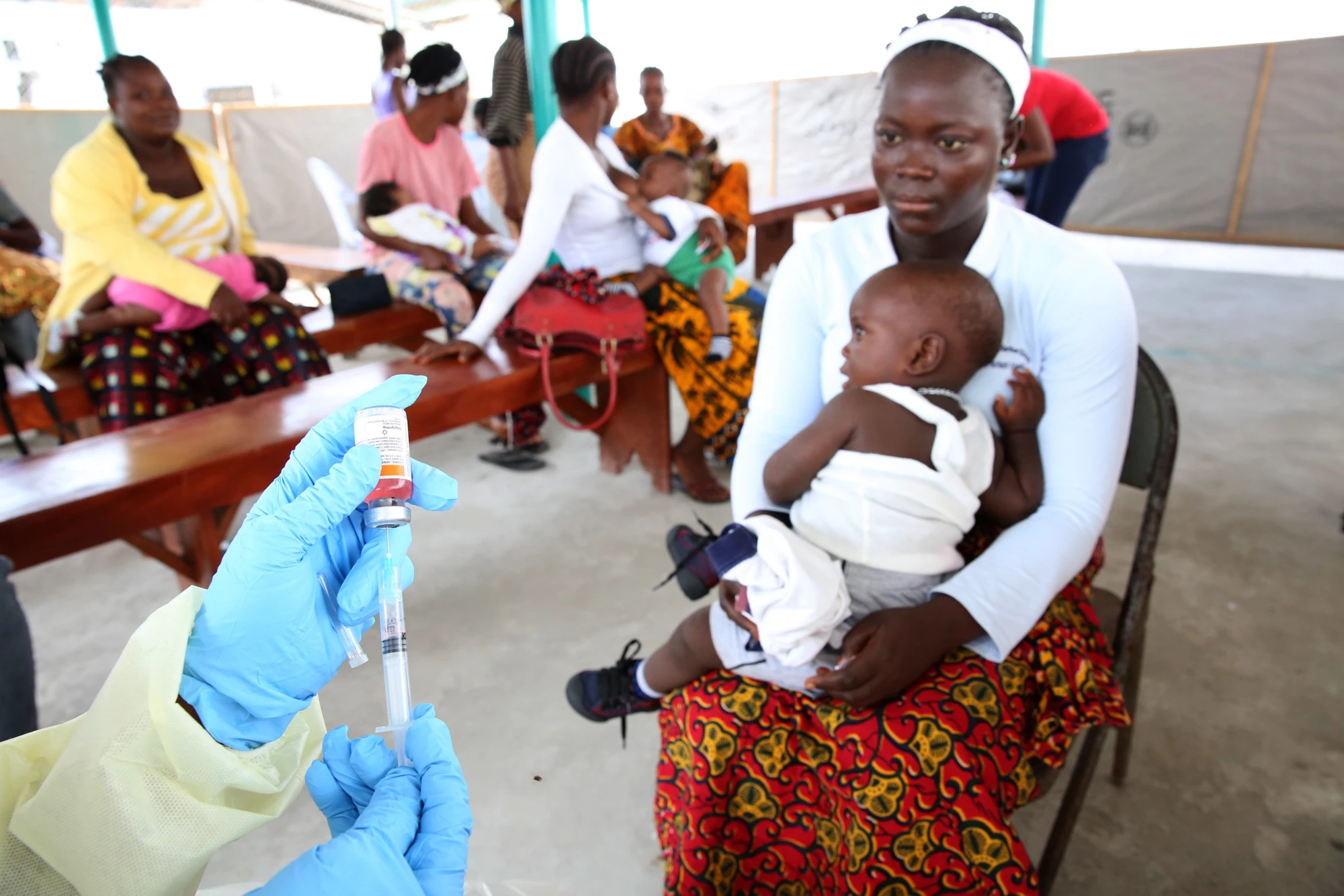 Jestina Wright a nurse (hands in photo) prepares to vaccinate children at Redemption Hospital in Monrovia, Liberia on March 2, 2015. Photo © Dominic Chavez/World Bank 