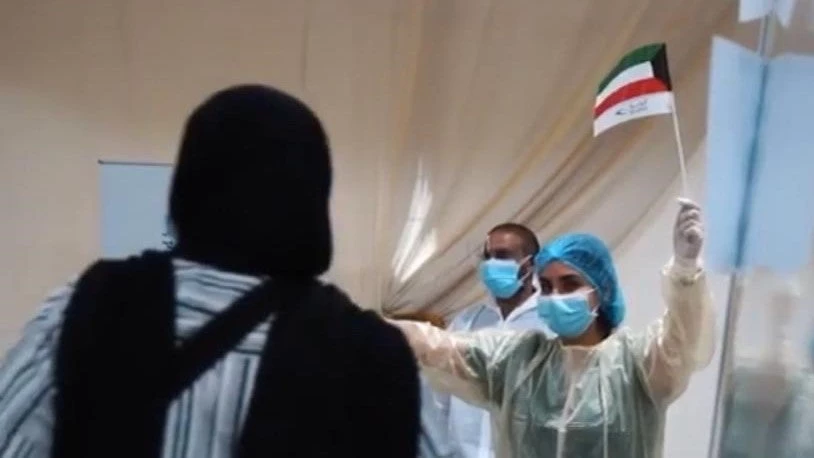 Women greeting a passenger at Kuwait airport during COVID19 pandemic.