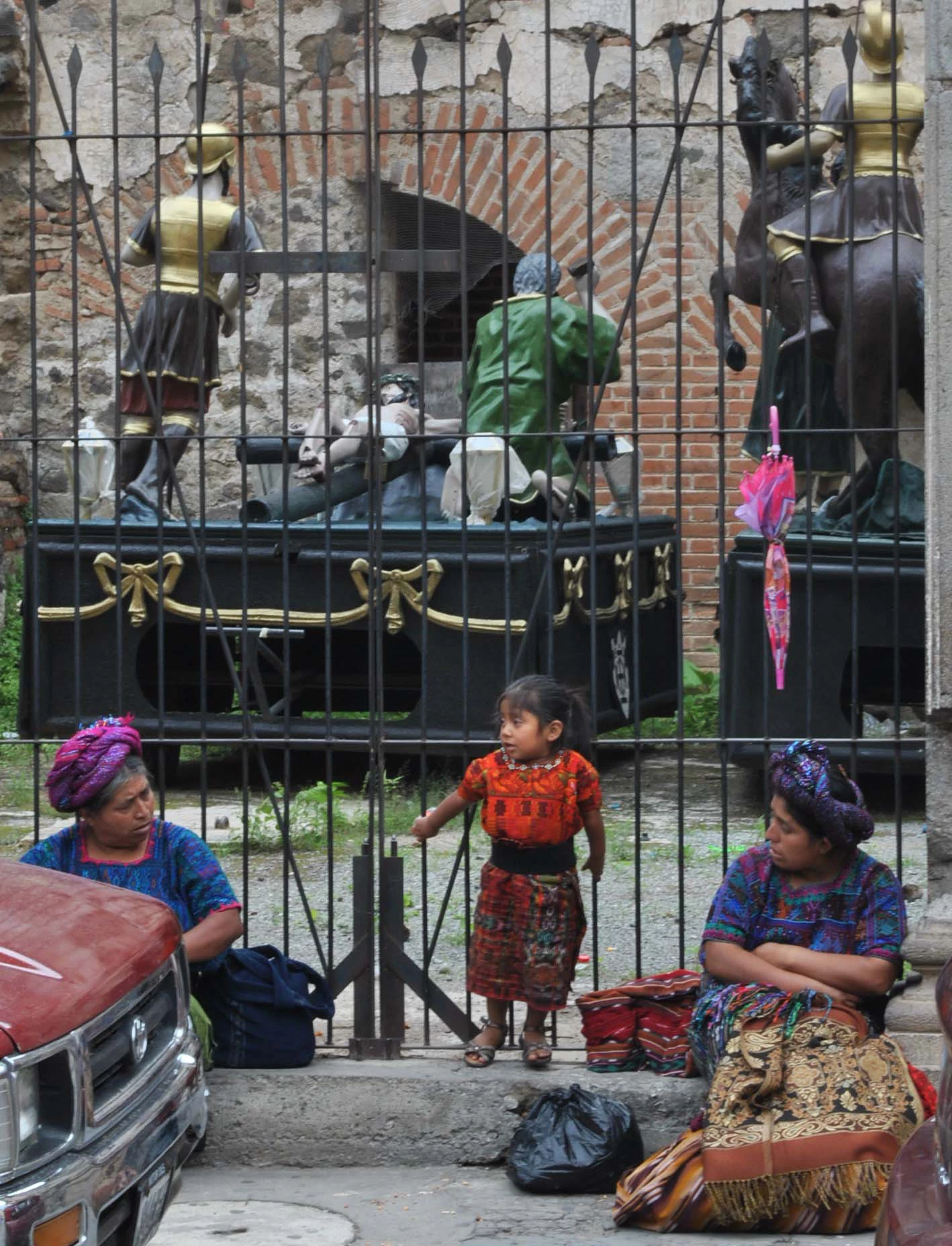 Artisans rest near a couple of pasos, the religious wooden statues used during the Easter processions